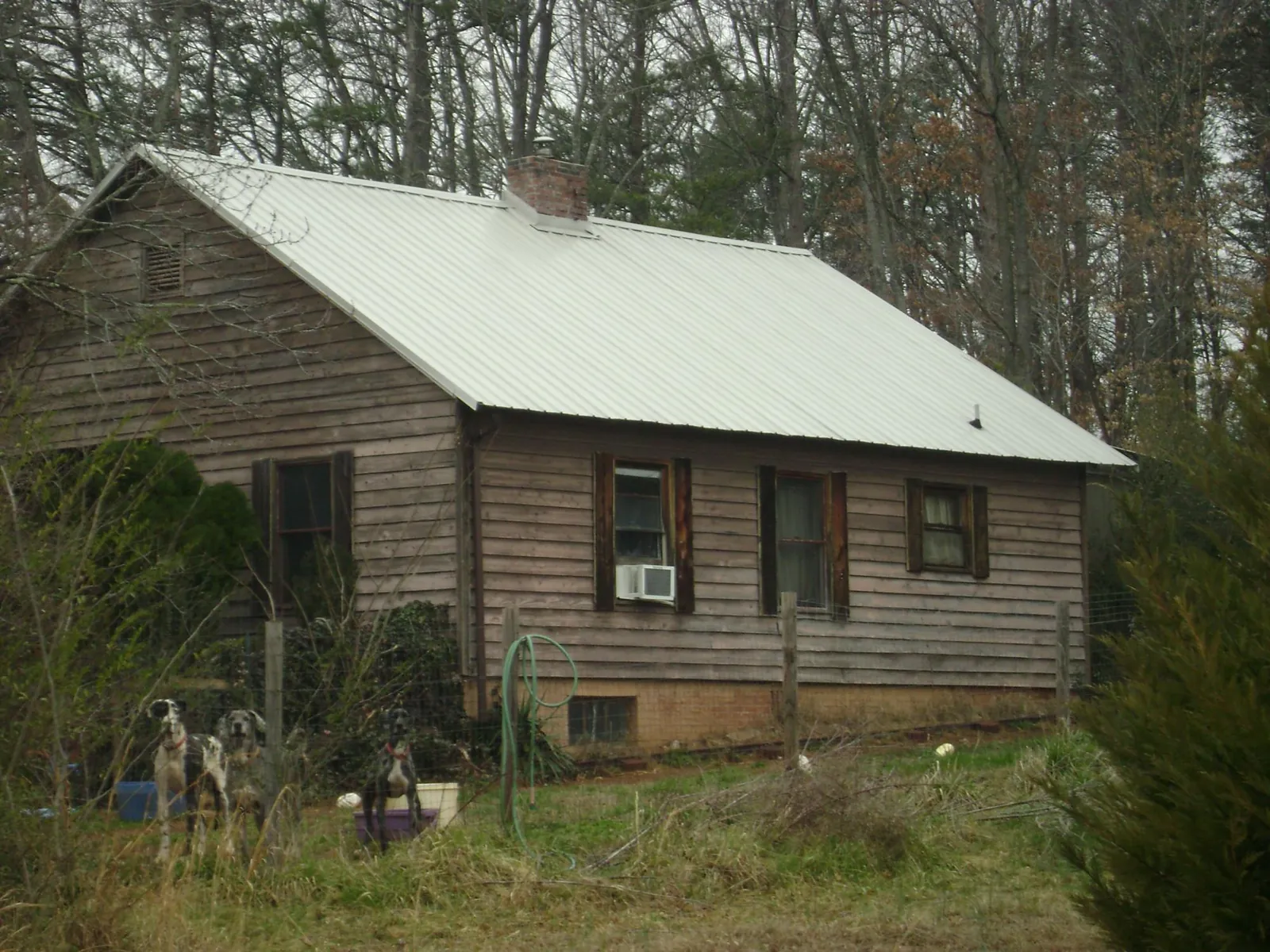 White metal roof on an old wood sided farmhouse, from a Asphalt Shingle Roof Repair job in Patrick
